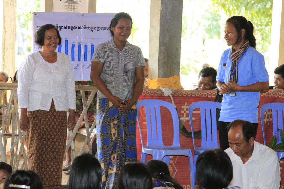 Villagers are listening to the presentation of their village chief acting as the sale agent during the sale event